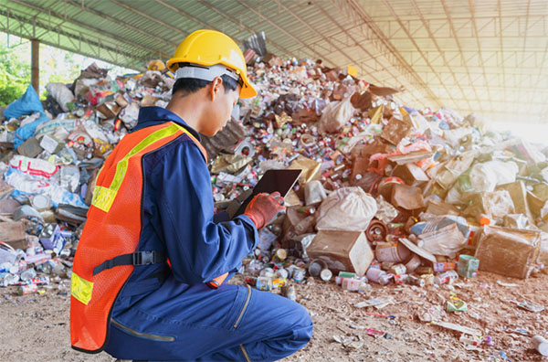 A waste collector using a tablet to monitor trash levels