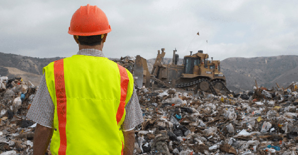 A waste collector at a landfill site