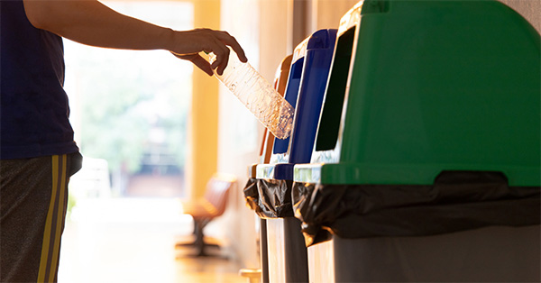 Using bins to recycle a plastic bottle