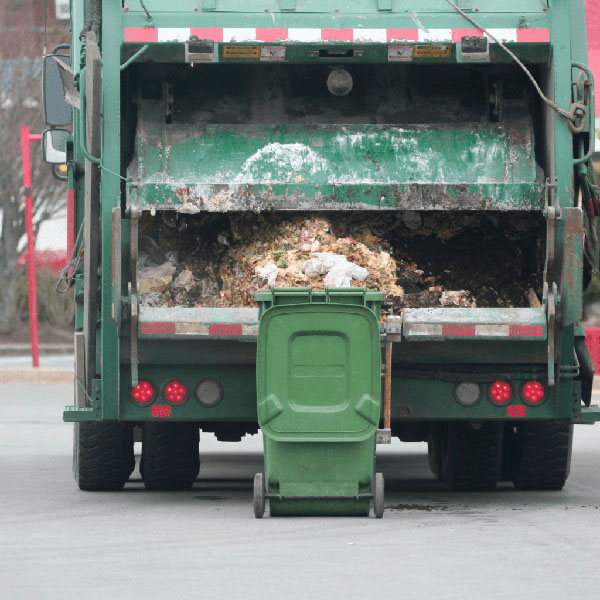A bin just emptied by a garbage truck