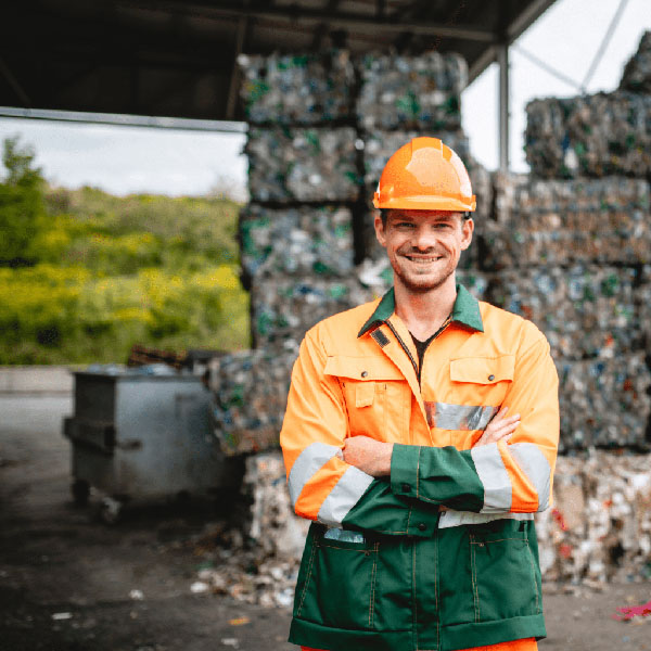 A waste worker in protective clothing